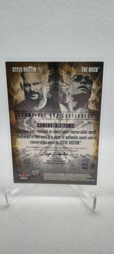 2004 Fleer WWE CCS-SA The Rock Steve Austin Authentic Event-Used Material Card